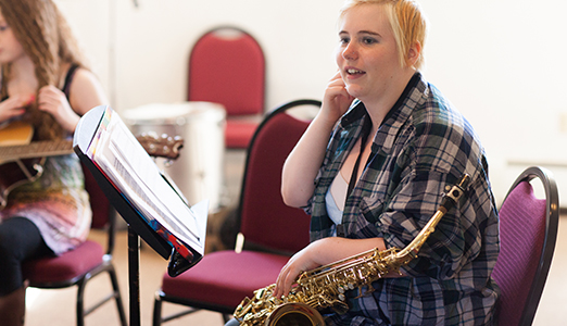 A female students attends jazz ensemble practice.