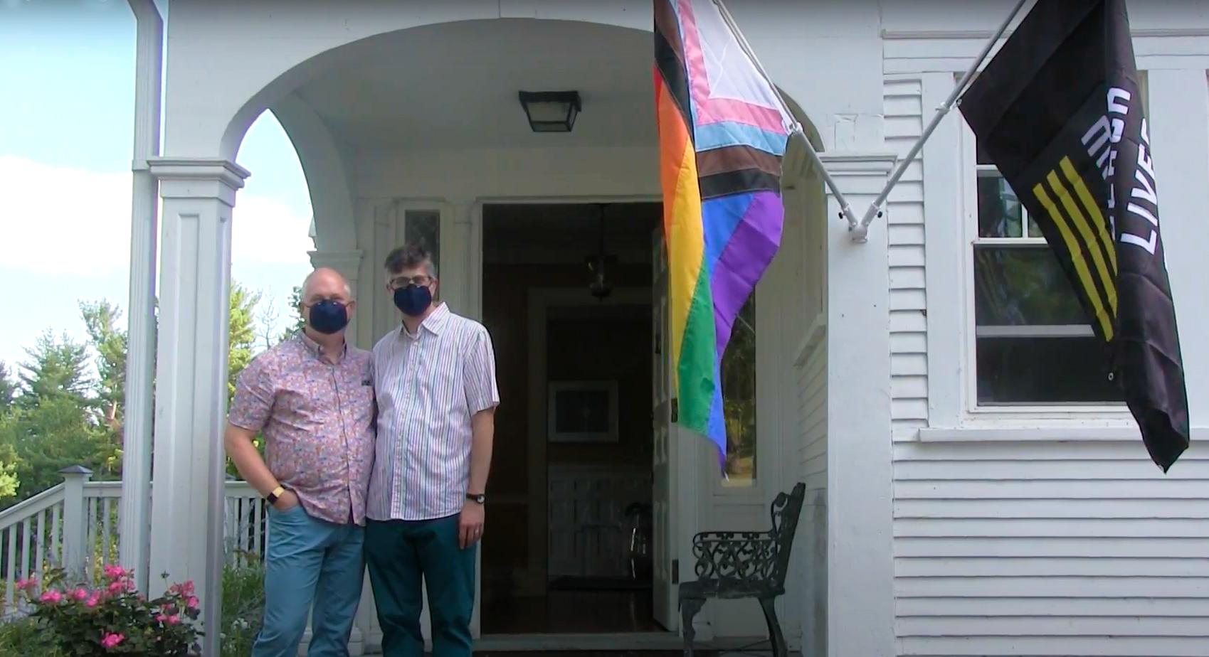 John Weinstein and Brian Mikesell in front of Whitehouse with pride and black lives matter flags