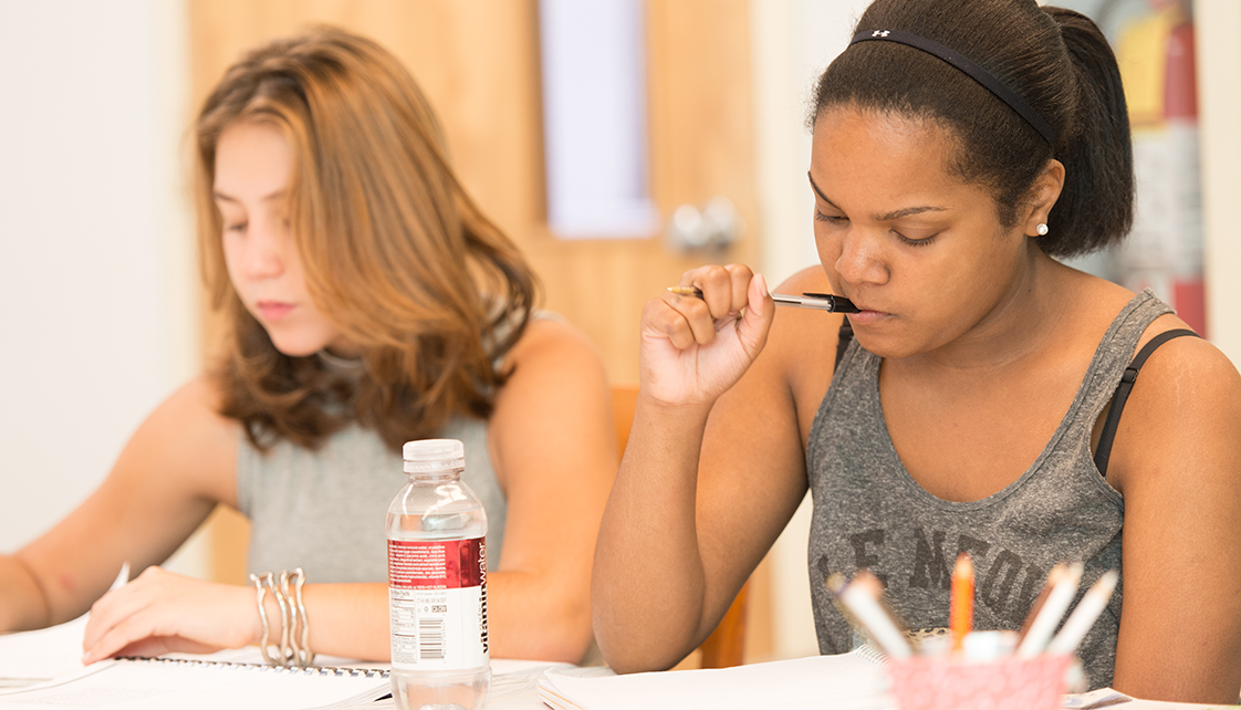 Students concentrating on writing