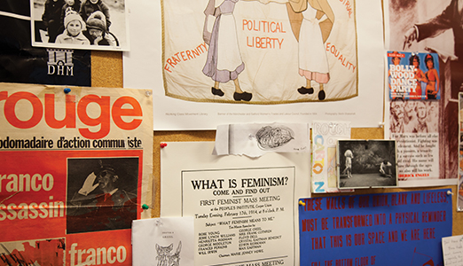 Office board with poster about feminism.