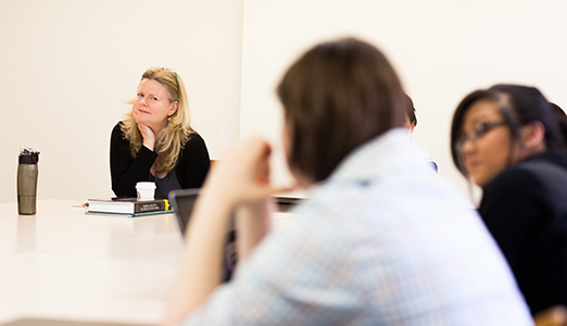 Professor of Psychology works with students during class.