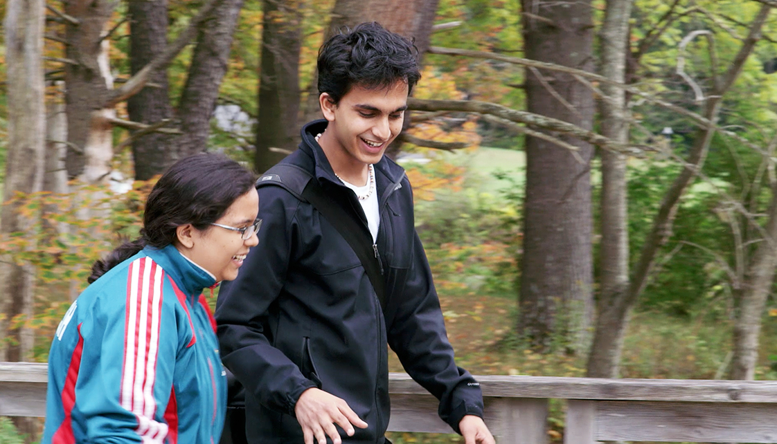 Ishan Guru walking on path with friend