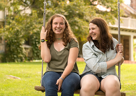 Two alumni on swing
