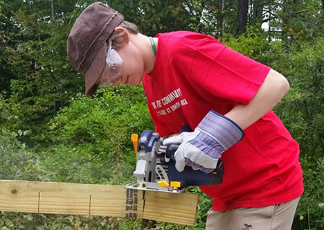 Student helps repair interpretive trail