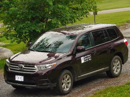 The campus safety vehicle is a maroon sport utility