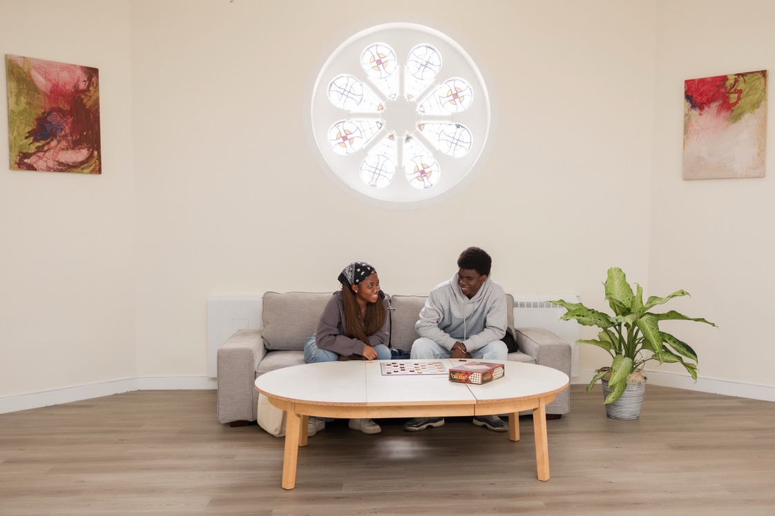 Male and female student in student lounge