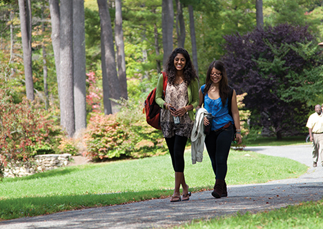 Female students walking on path.